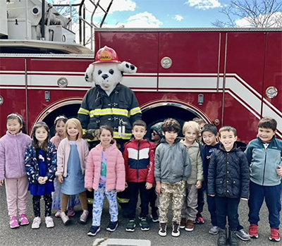 Students enjoying a visit from the Paramus Fire Department and their mascot