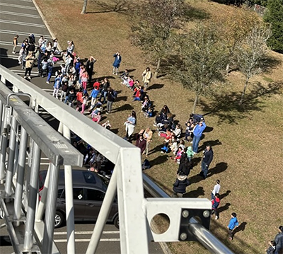 Aerial shot of students gathering around the fire truck presentation