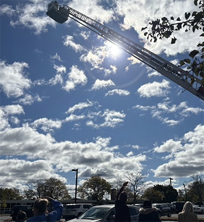 View of truck ladder rising over the blue sky